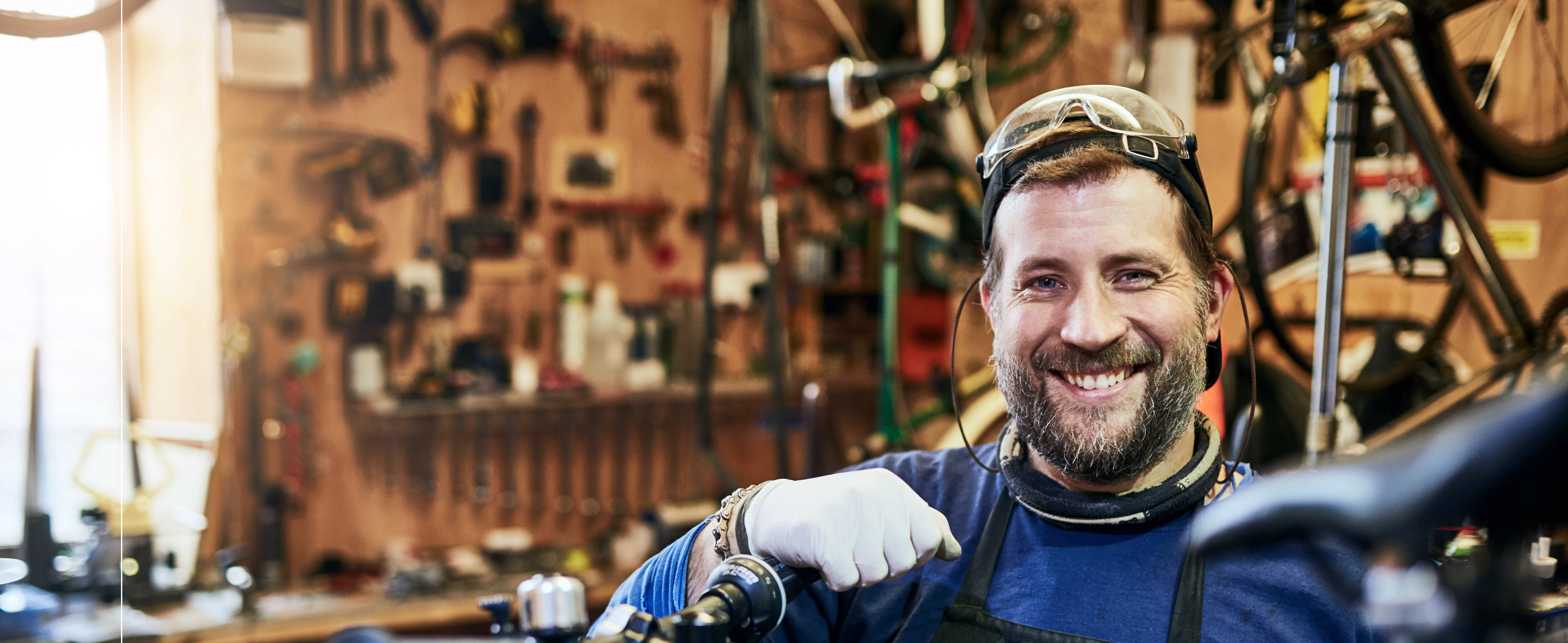smiling_bearded_man_operates_business_repair_mountainbike_comoxvalley_britishcolumbia